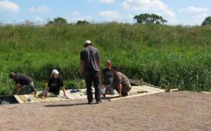 Volunteer group building pond-dipping platform