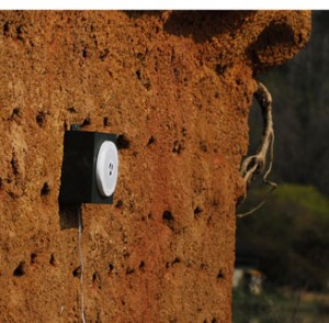 Waterproof speaker on the nesting bank plays the sounds of a busy sand martin colony.