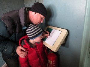 A young naturalist logging his first sighting from the new Headley Discovery Hide