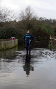 WWT Arundel Centre Manager Dave Fairlamb standing in water along the pathways to the visitor centre.