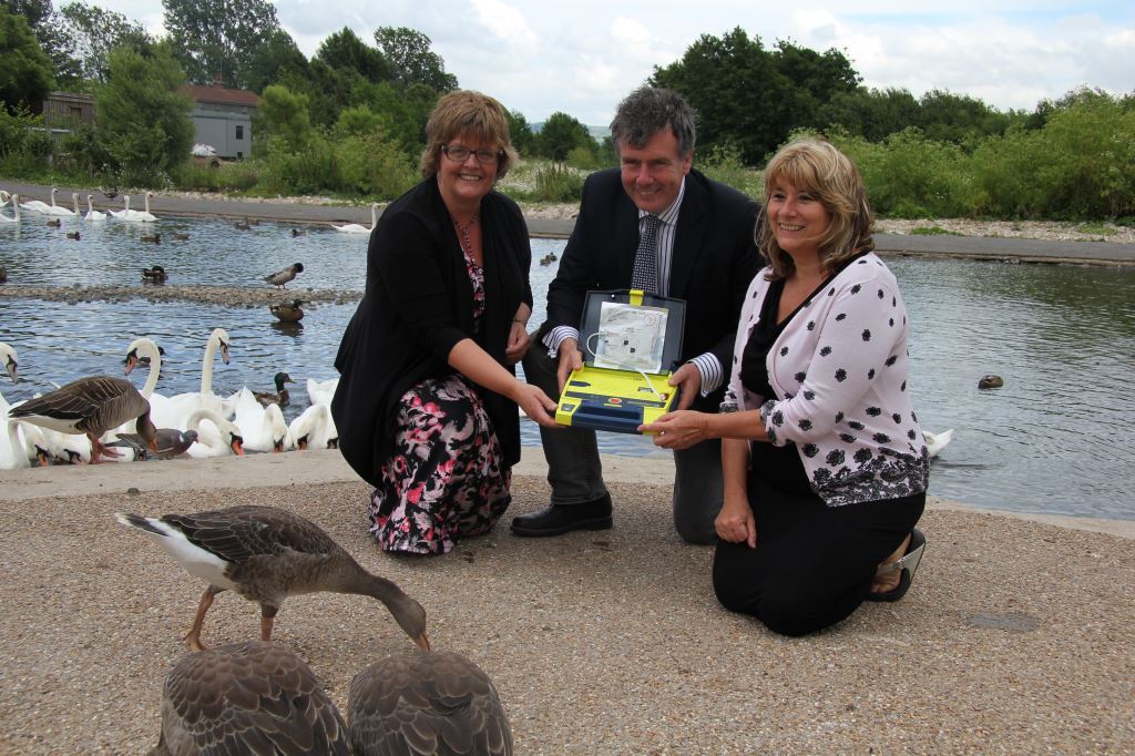 Heater Strawbridge, Chairman of SWASFT, Stroud MP Neil Carmichael and Slimbridge general manager Veronica Chrisp with the defibrillator