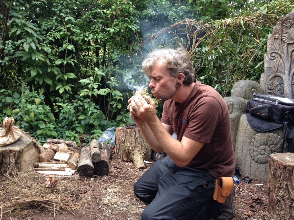 Jonathon Huet lights a fire to cook wild berry syrup at the Foraging & Firelighting workshop at WWT Arundel.