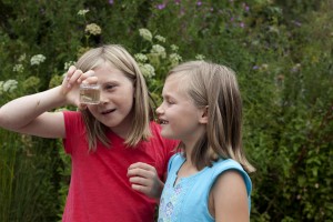 Two students fascinated by the stickleback they have just caught