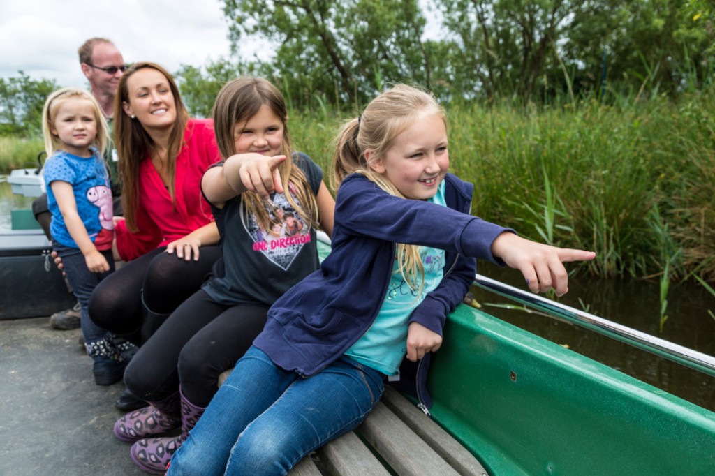 Family on a boat safari at Martin Mere