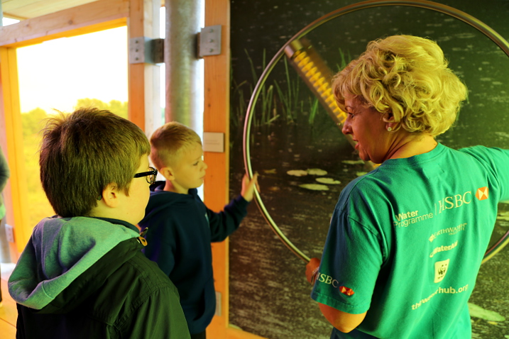 Year 4 pupils and HSBC's Sue Alexander tries out the giant rainmaker (c) Ed Waldron WWT