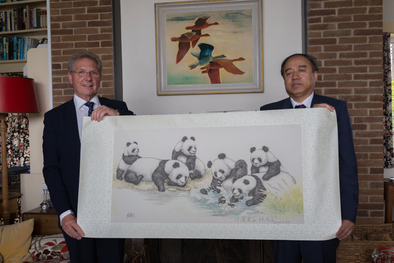 Vice Minister Mr Chen Fengxue presents Mr Martin Spray with an original drawing of panda cubs playing