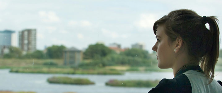 A woman looking out over a WWT wetland centre 