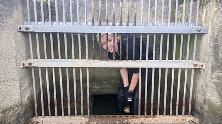 WWT reserve warden peeking out from behind sluice gate