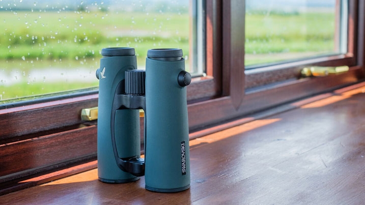 A pair of Swarovski binoculars by the window in a bird hide