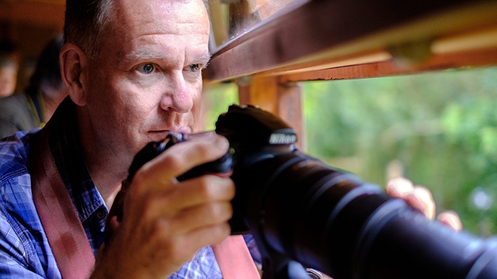 visitor taking photographs in hide