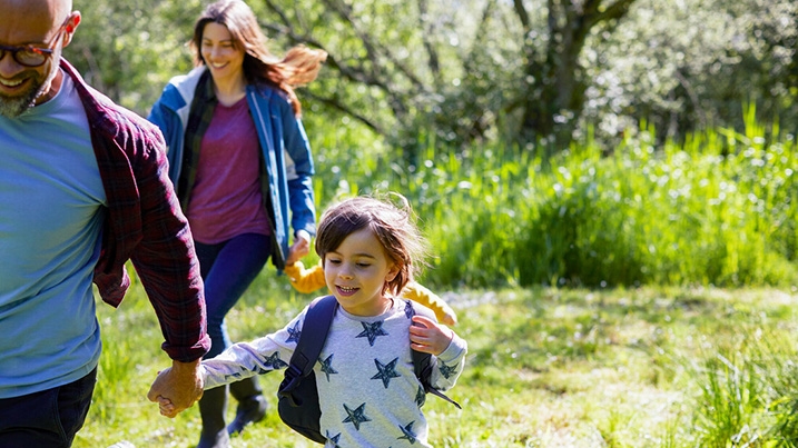 Family running through grass