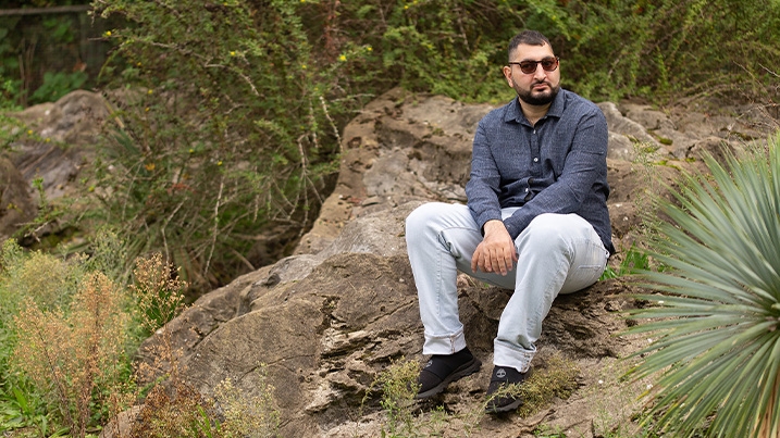 Harune sitting on a big boulder