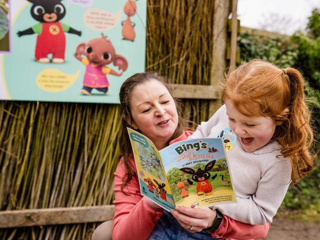 Girl with her mother reading the Bing trail card