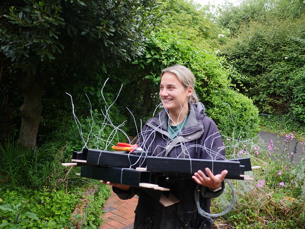 Hannah carries tubes 768x1024.jpg