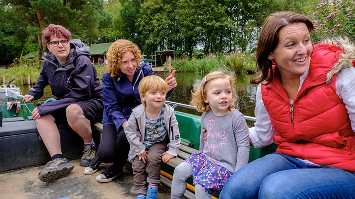 A family enjoying a canoe safari at WWT Martin Mere