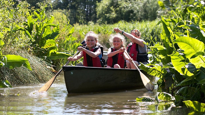 A family enjoying a canoe safari at WWT Martin Mere