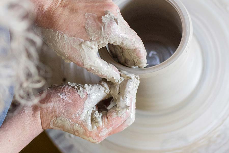 Tracey working at her wheel, turning a pot