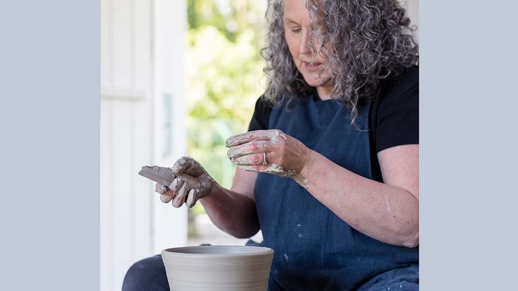 Tracey Johnston demonstrating how to throw at the potter's wheel at WWT Castle Espie