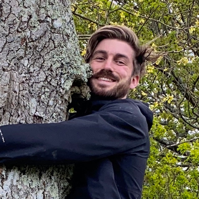 An image of Leif Bersweden hugging a tree