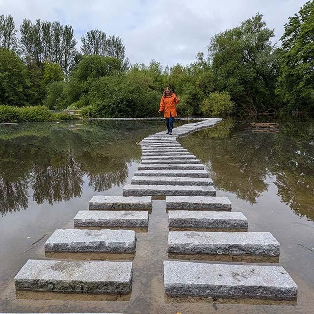 Families walking across Europe's longest continuous stretch of stepping stones at Martin Mere, Lancashire