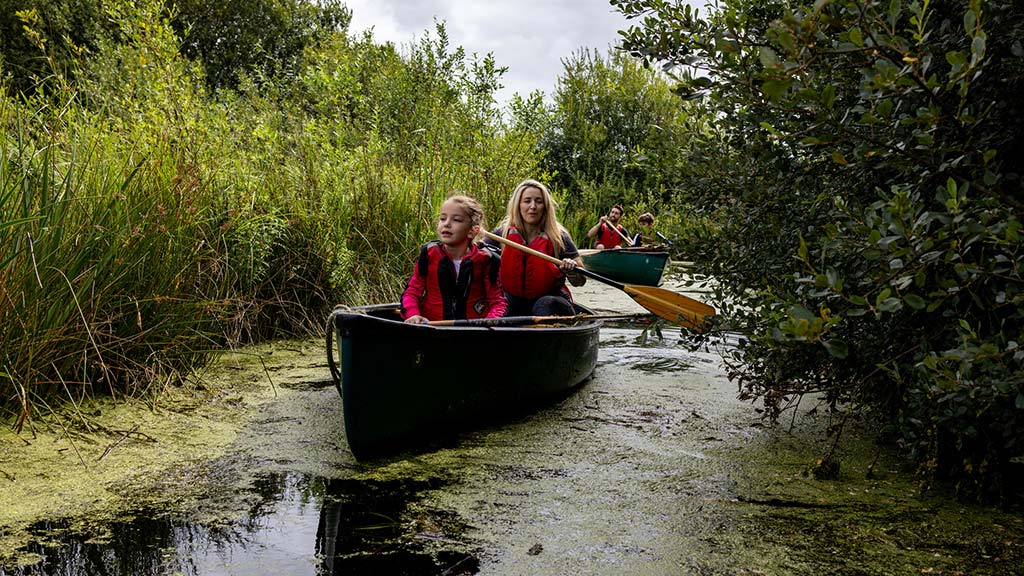 A family enjoying a canoe safari at WWT Martin Mere